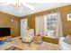 Comfortable living room featuring neutral tones, a floral armchair and ample natural light at 205 Person St, Oxford, NC 27565