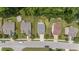Overhead shot of three homes on a street with a view of their rooftops and surrounding greenery at 205 Willow Weald Ct, Fuquay Varina, NC 27526