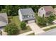 Aerial view of a well-maintained home with a two-car garage, surrounded by lush greenery at 205 Willow Weald Ct, Fuquay Varina, NC 27526