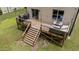 The back of the home features a wooden deck with stairs at 205 Willow Weald Ct, Fuquay Varina, NC 27526