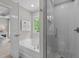Bright bathroom features a soaking tub, separate tiled shower with glass door, and a window view at 205 Willow Weald Ct, Fuquay Varina, NC 27526