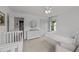 Bright bedroom features white walls, carpet, and a ceiling fan at 205 Willow Weald Ct, Fuquay Varina, NC 27526