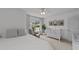 Bright bedroom features a ceiling fan and view of the neighborhood at 205 Willow Weald Ct, Fuquay Varina, NC 27526