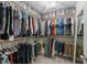 Organized walk-in closet with ample hanging space and shelving for clothing and accessories at 205 Willow Weald Ct, Fuquay Varina, NC 27526