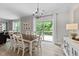 Dining room with a view to deck, hanging chandelier, and neutral color scheme at 205 Willow Weald Ct, Fuquay Varina, NC 27526