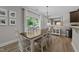 Dining room with backyard access, updated light fixtures, and neutral color scheme at 205 Willow Weald Ct, Fuquay Varina, NC 27526