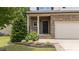 Inviting front entrance with stone accents, a black front door, and well-maintained landscaping at 205 Willow Weald Ct, Fuquay Varina, NC 27526
