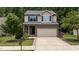 Charming two-story home with a stone facade and a two-car attached garage at 205 Willow Weald Ct, Fuquay Varina, NC 27526