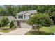 Charming home with stone accents, a two-car garage, and lush landscaping at 205 Willow Weald Ct, Fuquay Varina, NC 27526