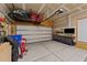 Spacious two car garage with high ceilings, storage racks, and a work bench at 205 Willow Weald Ct, Fuquay Varina, NC 27526