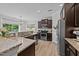 Bright kitchen features granite countertops, stainless steel appliances, and wood-look flooring at 205 Willow Weald Ct, Fuquay Varina, NC 27526