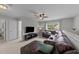 Spacious living room with a large sectional sofa, a ceiling fan, and natural light at 205 Willow Weald Ct, Fuquay Varina, NC 27526