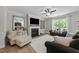 Living room features plush seating, decorative mirror and a cozy fireplace at 205 Willow Weald Ct, Fuquay Varina, NC 27526