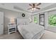 Bright main bedroom with a ceiling fan, tray ceiling, and an abundance of natural light at 205 Willow Weald Ct, Fuquay Varina, NC 27526