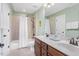 Bright bathroom with double vanity, tiled shower, and modern fixtures at 215 Dungarven Loop, Cary, NC 27513