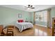Cozy bedroom with hardwood floors, natural light, and comfortable furnishings at 215 Dungarven Loop, Cary, NC 27513