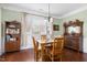Charming dining room with natural light, hardwood floors, and classic furniture, perfect for meals at 215 Dungarven Loop, Cary, NC 27513
