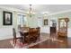 Dining room with hardwood floors, natural light, and elegant decor, ideal for gatherings at 215 Dungarven Loop, Cary, NC 27513