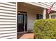 Covered entrance featuring a decorative glass front door, brick pavers, and an American flag at 215 Dungarven Loop, Cary, NC 27513