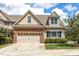 Charming two-story home with a brick and beige exterior and well-maintained landscaping at 215 Dungarven Loop, Cary, NC 27513