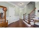 Welcoming foyer with hardwood floors, staircase, and elegant trim details at 215 Dungarven Loop, Cary, NC 27513