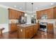 Beautiful kitchen with stainless steel appliances, granite countertops, and hardwood floors, perfect for cooking at 215 Dungarven Loop, Cary, NC 27513