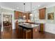 Kitchen featuring granite countertops, stainless steel appliances, and a kitchen island with seating at 215 Dungarven Loop, Cary, NC 27513
