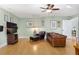 Inviting living room features a comfortable leather sofa, chair with ottoman, and modern entertainment center at 215 Dungarven Loop, Cary, NC 27513