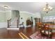 Open living area with hardwood floors, staircase, and abundant natural light at 215 Dungarven Loop, Cary, NC 27513