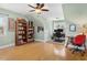 Office with natural light, bookshelf, hardwood floors, and workstation at 215 Dungarven Loop, Cary, NC 27513