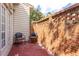 Cozy private patio featuring a brick wall and comfortable seating area at 215 Dungarven Loop, Cary, NC 27513