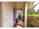 Cozy covered porch with brick flooring, neutral siding, and comfortable seating for relaxation at 215 Dungarven Loop, Cary, NC 27513