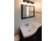 Bathroom sink vanity with a dark cabinet and neutral walls at 227 Shalimar Dr, Durham, NC 27713