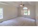 A spacious bedroom with carpet flooring, vaulted ceiling, and natural light from windows at 227 Shalimar Dr, Durham, NC 27713