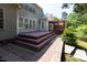 Back of house featuring siding, windows, deck, and brick paver patio at 227 Shalimar Dr, Durham, NC 27713