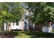 Charming brick home with a well-manicured lawn and mature trees at 227 Shalimar Dr, Durham, NC 27713