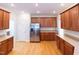 An open kitchen with stainless steel appliances, wooden cabinets, and hardwood floors at 227 Shalimar Dr, Durham, NC 27713