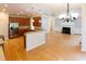 Open concept living room and kitchen area with hardwood floors and fireplace at 227 Shalimar Dr, Durham, NC 27713