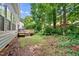A backyard with a wooden deck. Steps lead down to the yard space and natural growth at 2409 Horizon Hike Ct, Raleigh, NC 27603