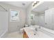 Bright bathroom featuring single vanity, tub, and natural light from the window at 2409 Horizon Hike Ct, Raleigh, NC 27603