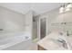 Bright bathroom features a soaking tub, glass shower, and double sink vanity at 2409 Horizon Hike Ct, Raleigh, NC 27603