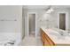 Bright bathroom featuring double sink vanity, large mirror, and shower at 2409 Horizon Hike Ct, Raleigh, NC 27603