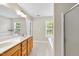 Bright bathroom featuring double sink vanity, tub, and natural light from the window at 2409 Horizon Hike Ct, Raleigh, NC 27603