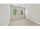 Neutral bedroom with two windows allowing for natural light and carpet flooring at 2409 Horizon Hike Ct, Raleigh, NC 27603