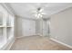 Neutral bedroom with carpet flooring, ceiling fan and a large window letting in natural light at 2409 Horizon Hike Ct, Raleigh, NC 27603