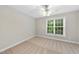 Neutral bedroom with carpet flooring and a large window letting in natural light at 2409 Horizon Hike Ct, Raleigh, NC 27603