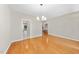 Hardwood floors and a modern light fixture create an elegant dining space at 2409 Horizon Hike Ct, Raleigh, NC 27603