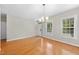 Dining room with hardwood floors, neutral paint, and large windows with street view at 2409 Horizon Hike Ct, Raleigh, NC 27603