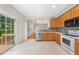 Bright kitchen featuring wood cabinets, stainless steel appliances, and a sliding glass door to the deck at 2409 Horizon Hike Ct, Raleigh, NC 27603