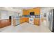 Kitchen with wood cabinets, modern appliances, and an open view to the fireplace at 2409 Horizon Hike Ct, Raleigh, NC 27603